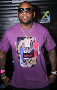 a man wearing sunglasses and a purple t - shirt