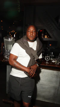 a man standing in front of a bar